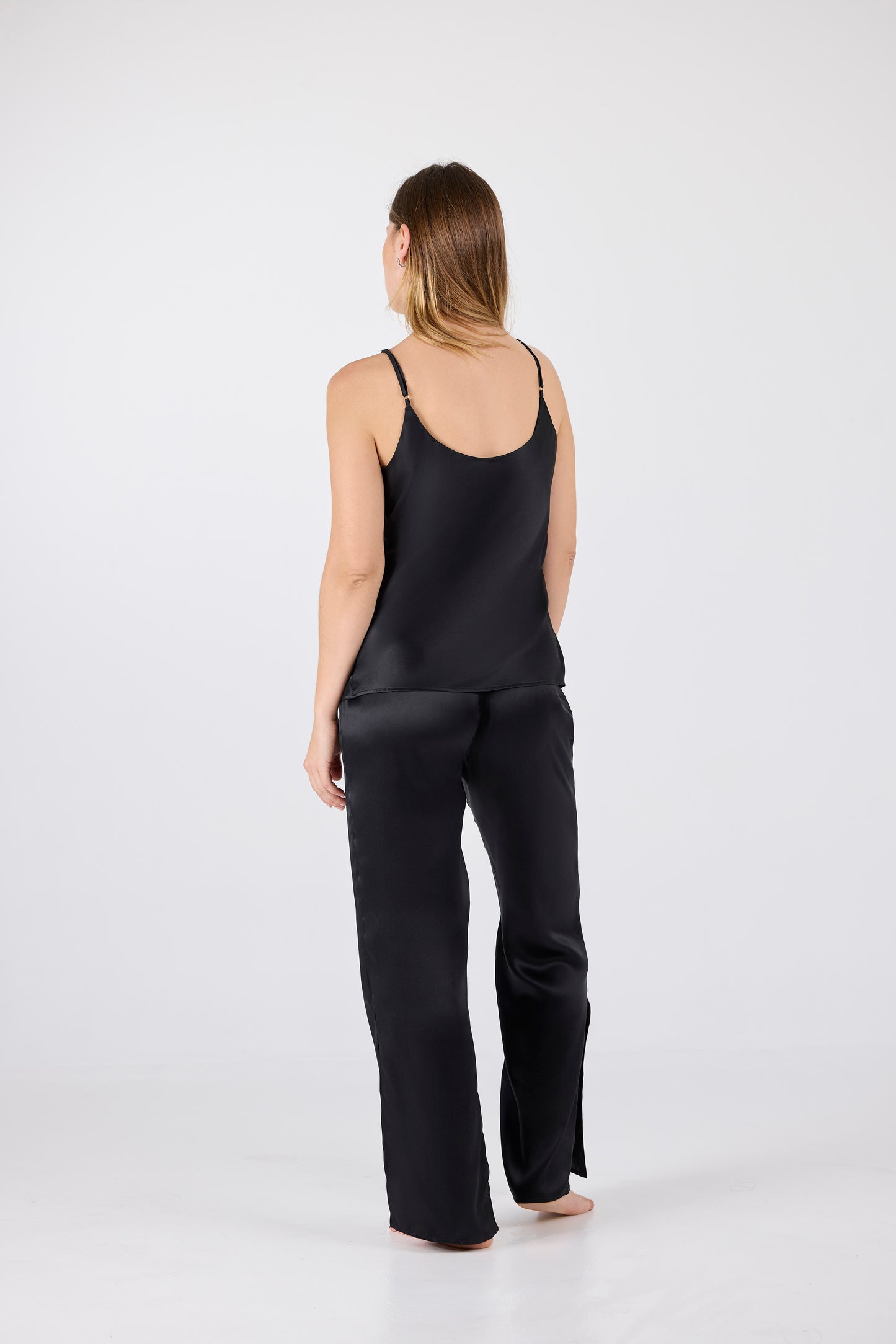 Back view of A.ROSE Juliet Set in black washable silk – minimal adjustable spaghetti strap tank and flowy high-slit pants with a soft elastic waistband. Luxe yet comfortable loungewear designed to move with you.