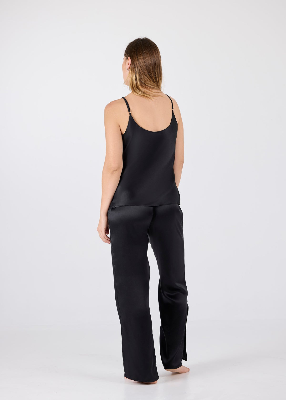 Back view of A.ROSE Juliet Set in black washable silk – minimal adjustable spaghetti strap tank and flowy high-slit pants with a soft elastic waistband. Luxe yet comfortable loungewear designed to move with you.