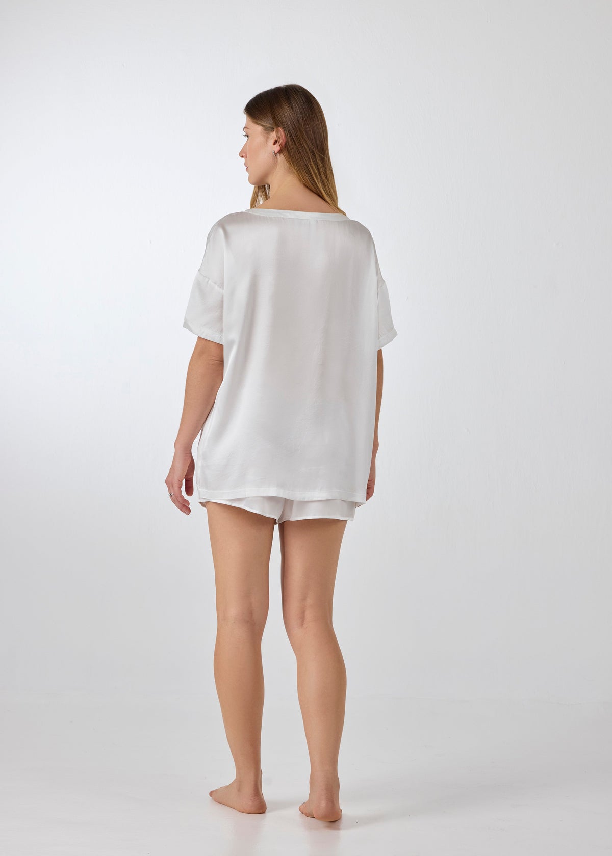 Back view of A.ROSE Luna Set in ivory washable silk – oversized short-sleeve tee draped over relaxed-fit shorts with soft elastic waistband, designed for elevated comfort at home or away. Loungewear or/and sleepwear.