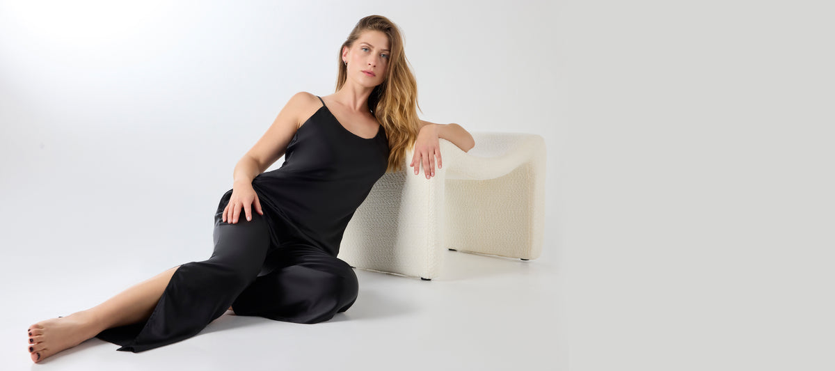 Woman lounging in a black A.ROSE silk set